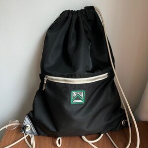 Prada Black Nylon Drawstring Backpack with White Trim and Green Logo
